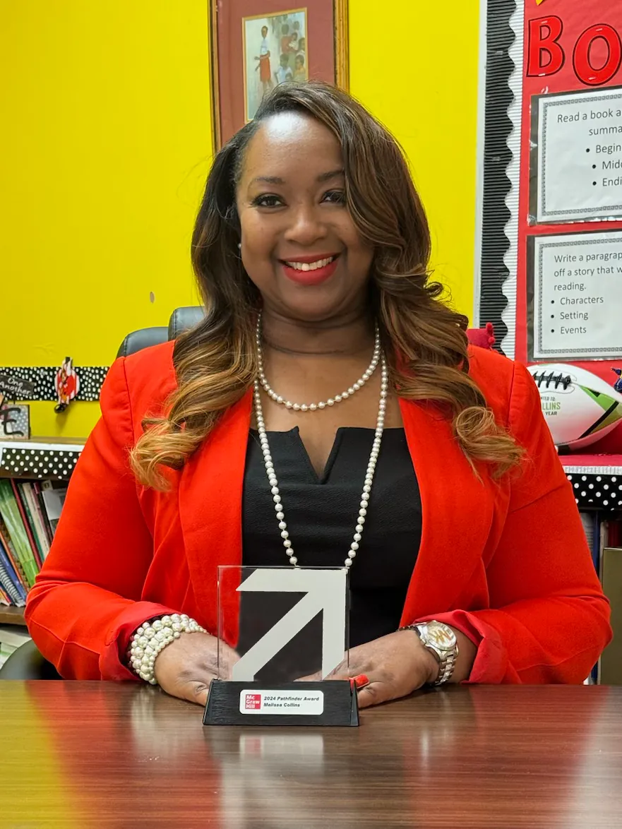Photo of Dr. Melissa Collins holding the 2024 Pathfinder Award