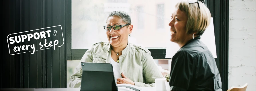 2 women smiling and laughing.