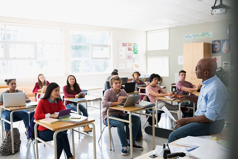 classroom setting with students intently watching a teacher