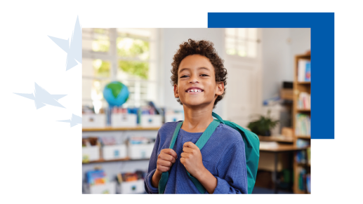 an elementary aged student holding onto backpack straps