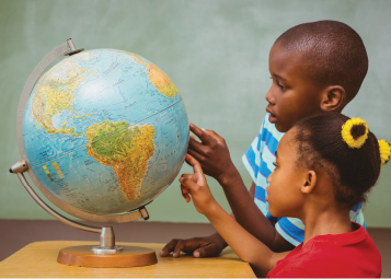 Two children point to locations on a globe. 