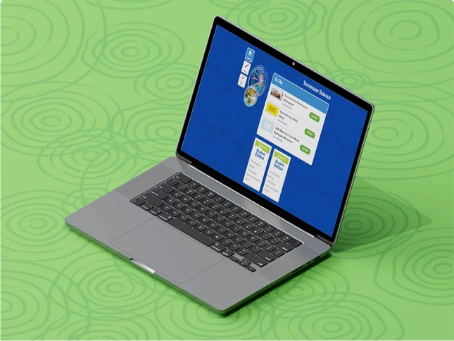 A laptop screen shows the Tennessee Science digital dashboard.